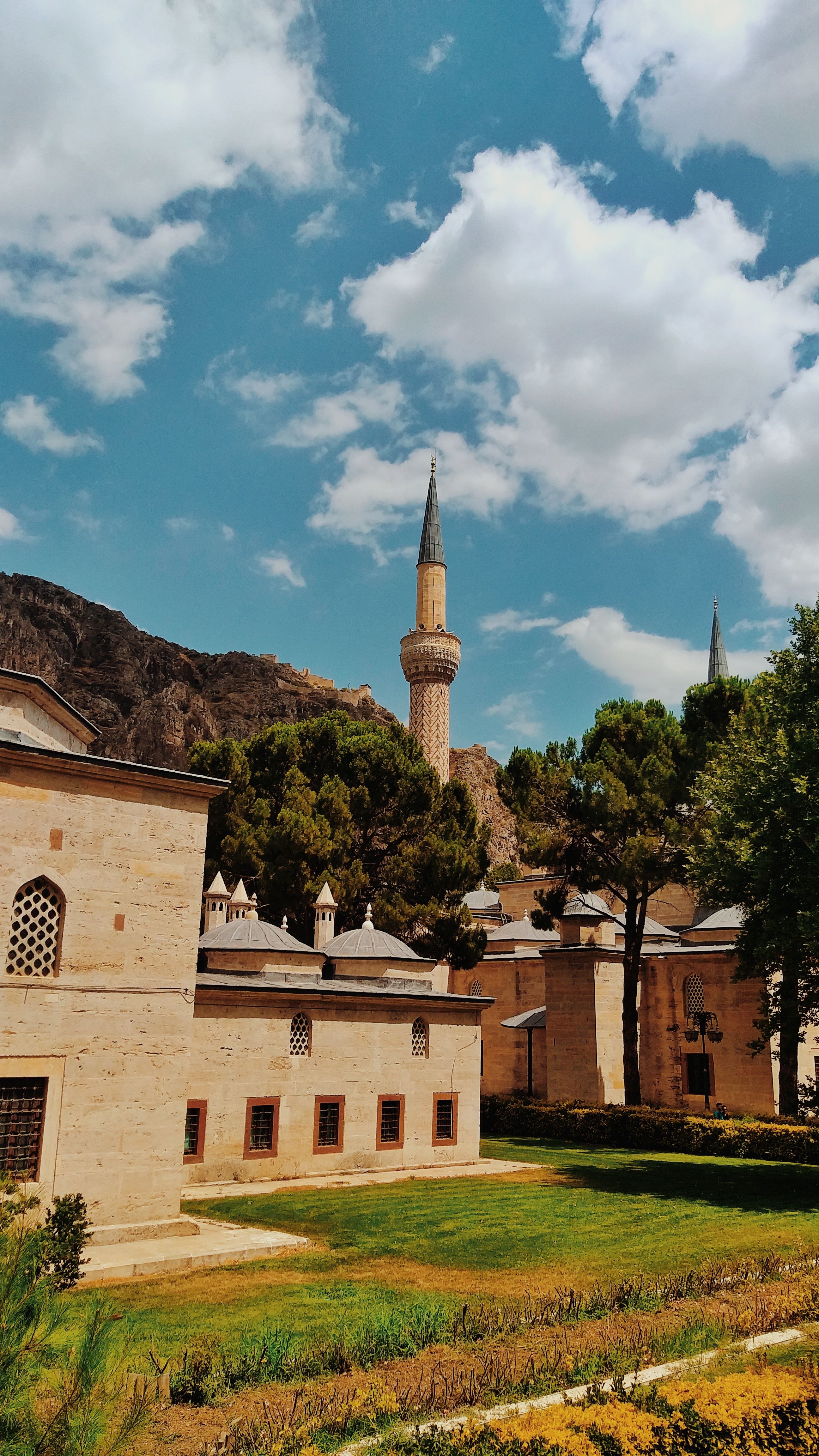 Beautiful mosque in Amasya, Türkiye against vibrant sky.