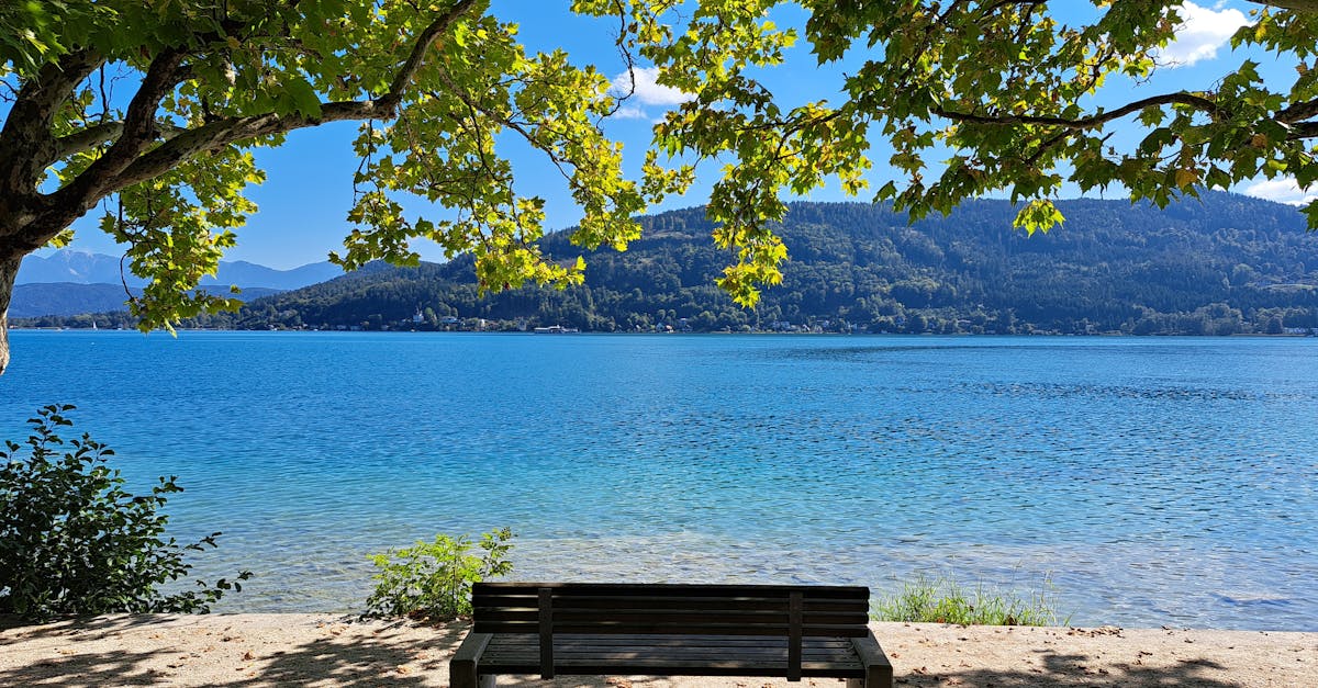 Peaceful bench by Wörthersee lake in Klagenfurt, Austria.