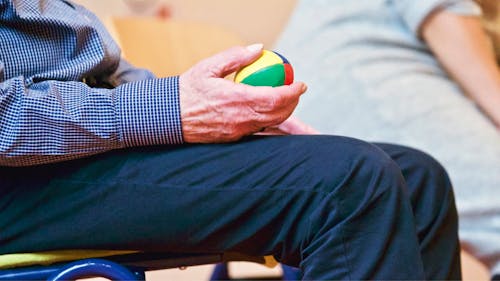 Person Holding Multicolored Ball