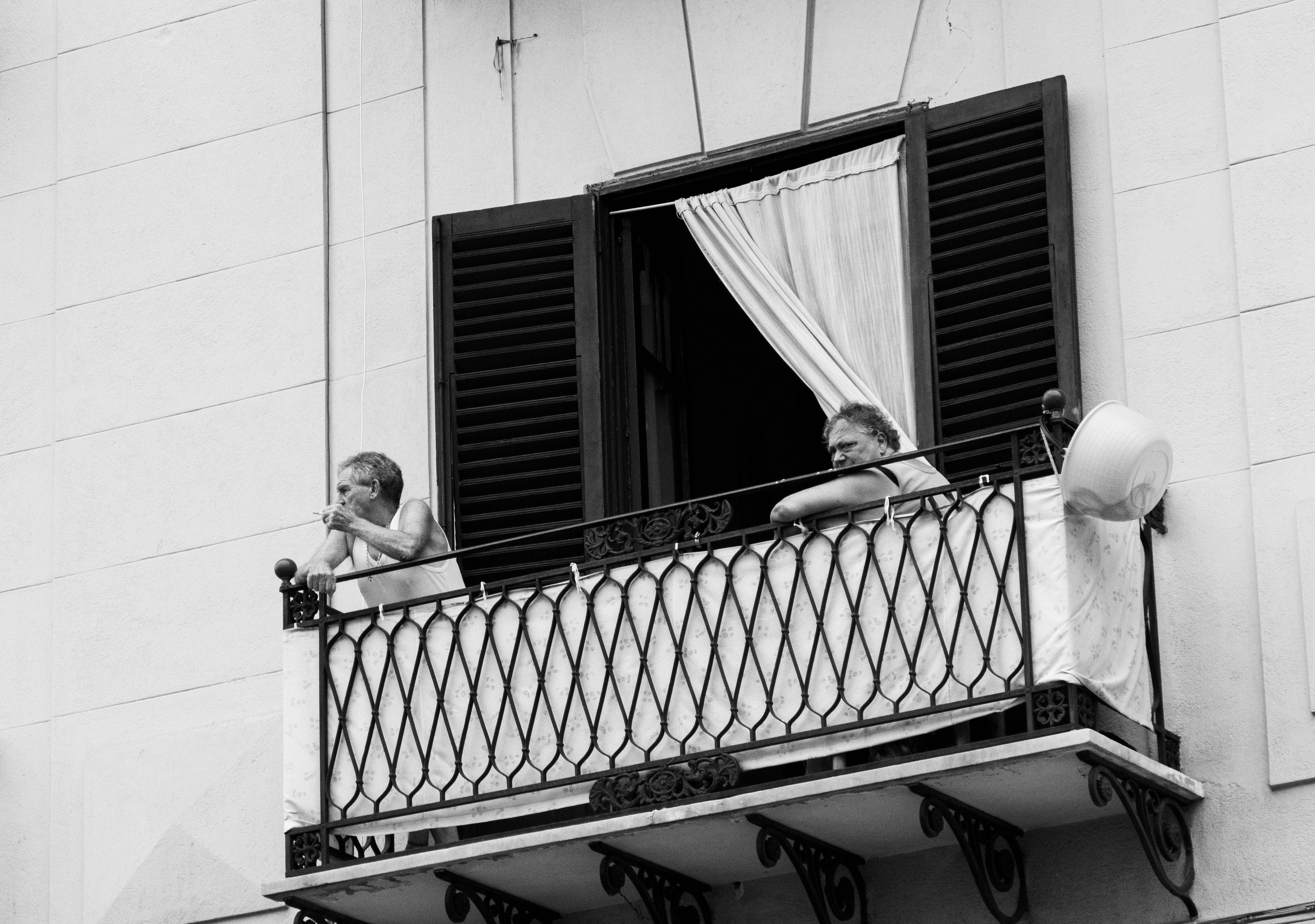 Elderly Couple Relaxing on Italian Balcony