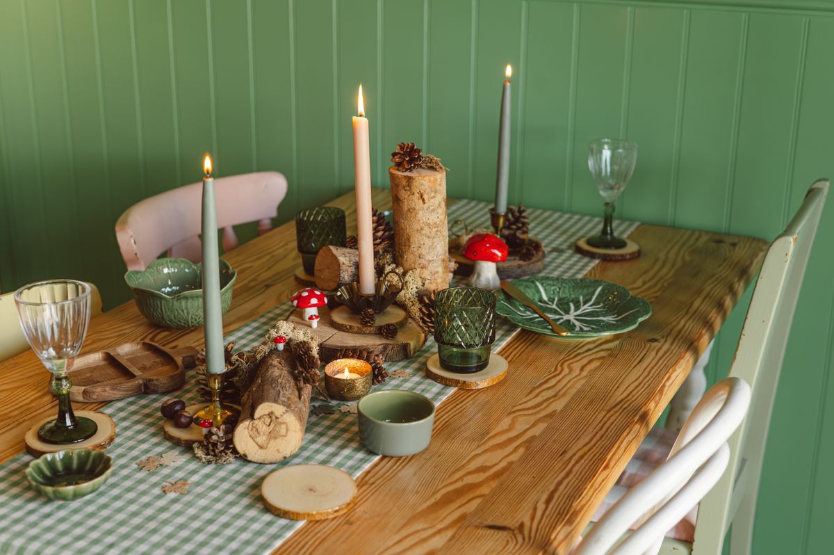 Rustic farmhouse Christmas dinner table with candles and wood elements