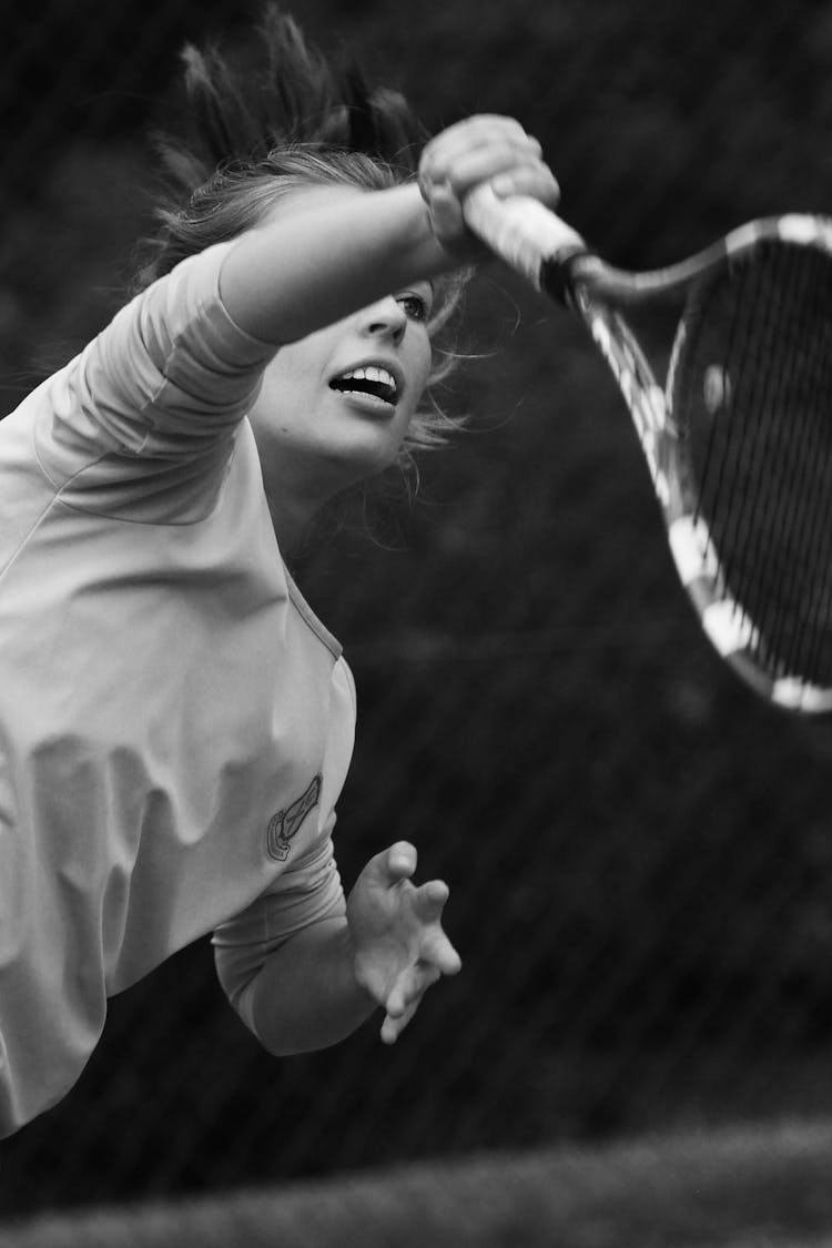 Grayscale Photo Of Woman Playing Tennis