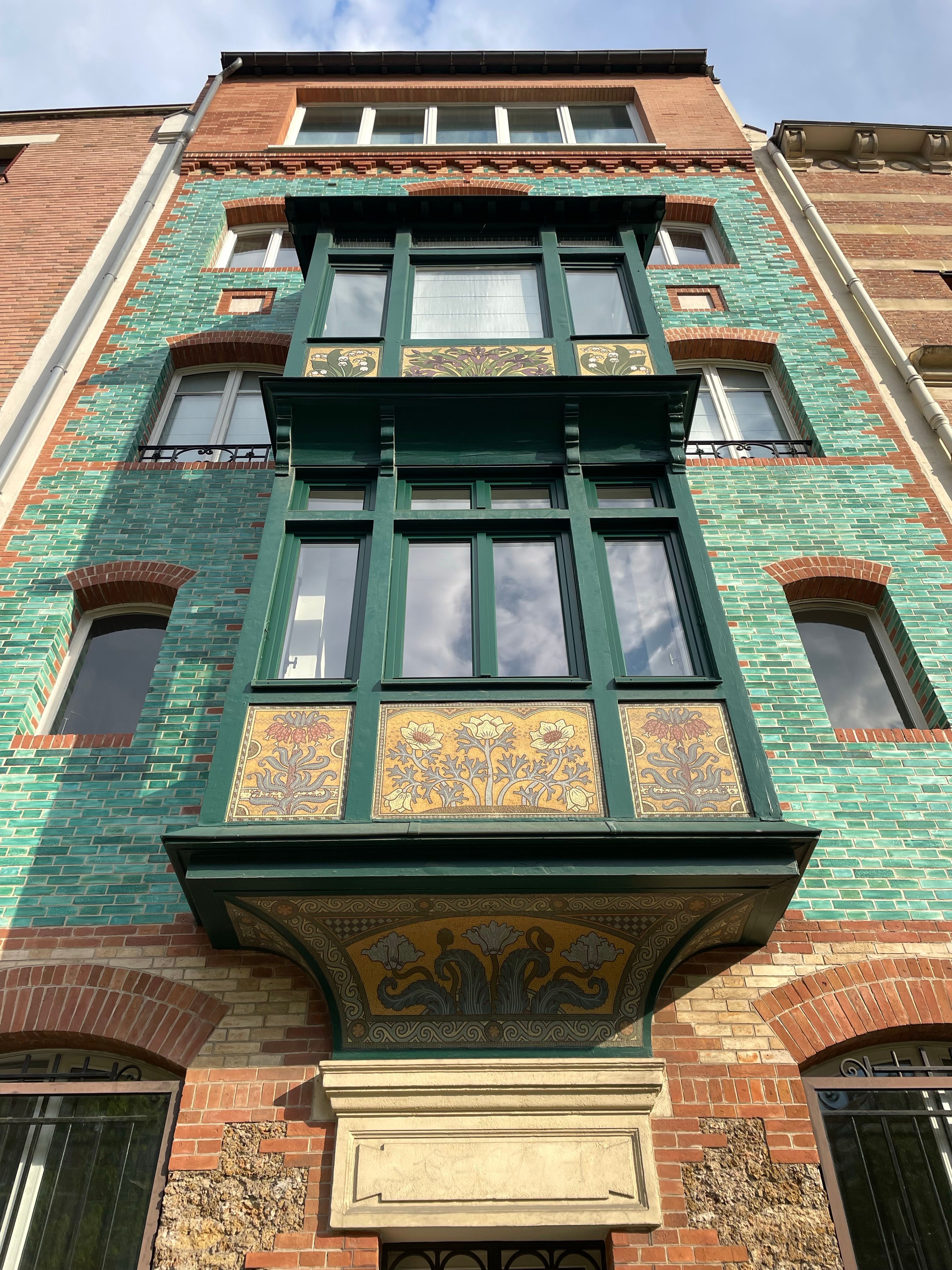 Explore this vibrant Art Nouveau building facade with intricate tile work and unique architecture.. pexels, explore, this