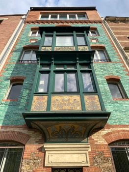 Explore this vibrant Art Nouveau building facade with intricate tile work and unique architecture.. pexels, explore, this