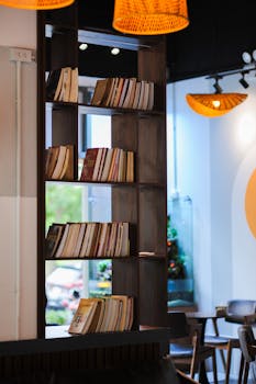 Warm, inviting coffee shop interior in Hà Nội with a stylish bookshelf and modern lighting.