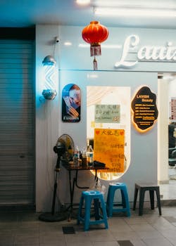 Explore a lively Singapore beauty salon at night, featuring colorful lights and cultural decor.