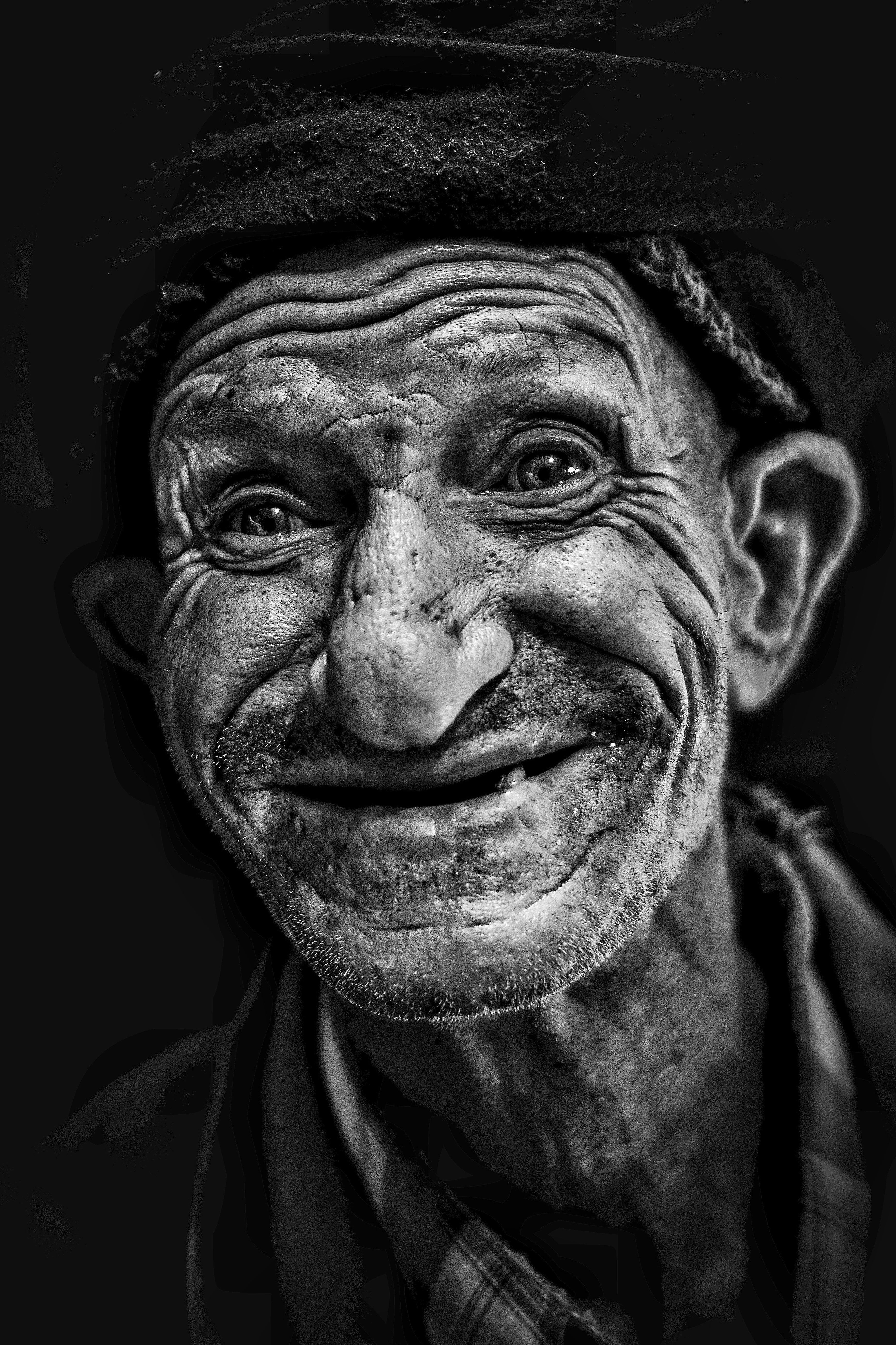 A striking black and white portrait capturing the expressive face of an elderly man in Morocco.
