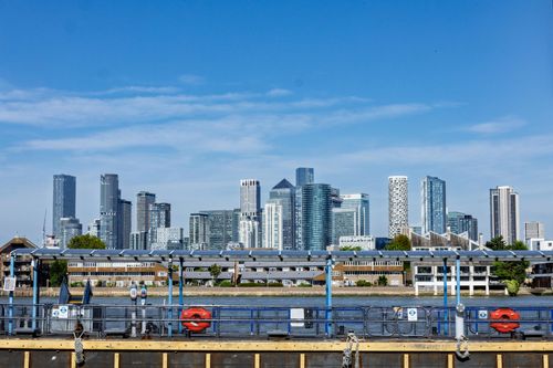 Free View of the iconic Canary Wharf skyline in London with blue skies and modern architecture. Stock Photo