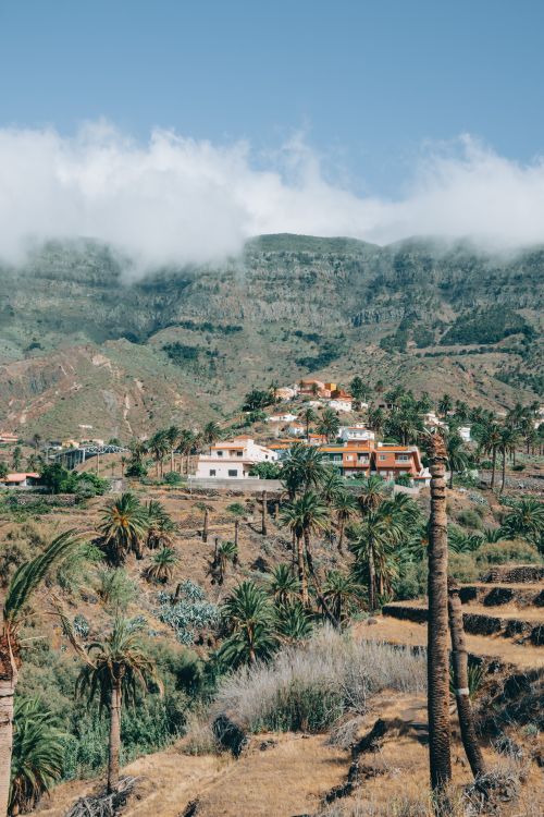 Free Picturesque village of Alojera in Canary Islands surrounded by lush hills and palm trees. Stock Photo