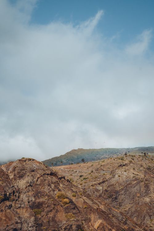 Free Scenic view of rugged cliffs under a cloudy sky in Alojera, Canary Islands. Stock Photo