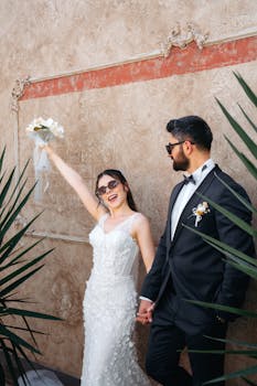 Joyful wedding couple celebrating outdoors in Antalya with bride holding bouquet.
