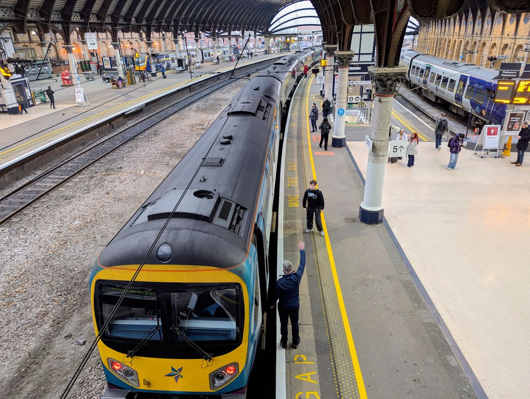 York station platform view showing car boards and signs for how to book train travel in europe planning