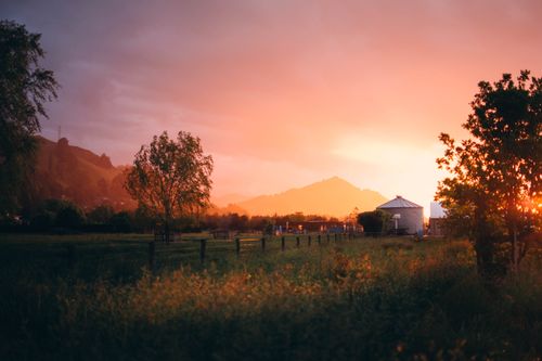 Free Beautiful sunset over the countryside in Nelson, New Zealand. Peaceful rural landscape. Stock Photo