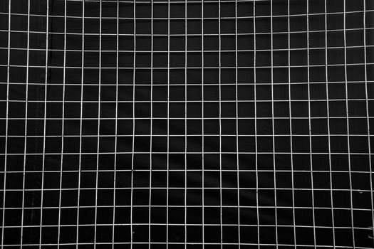 Black and white geometric grid pattern creates a textured background.