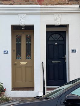 Distinctive colored doors side by side with house numbers 48 and 46.