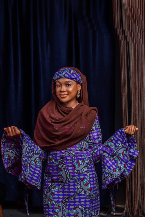 Free Portrait of a woman in vibrant traditional African attire indoors. Stock Photo