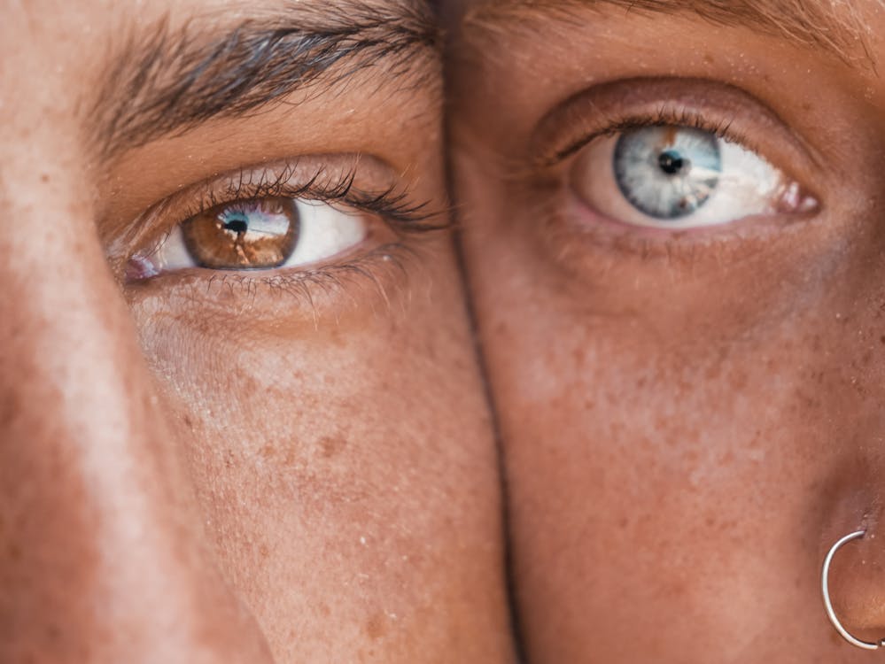 Portrait Photography of Two Person's Brown and Blue Eyes