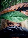 Woman Peeking on Leaves