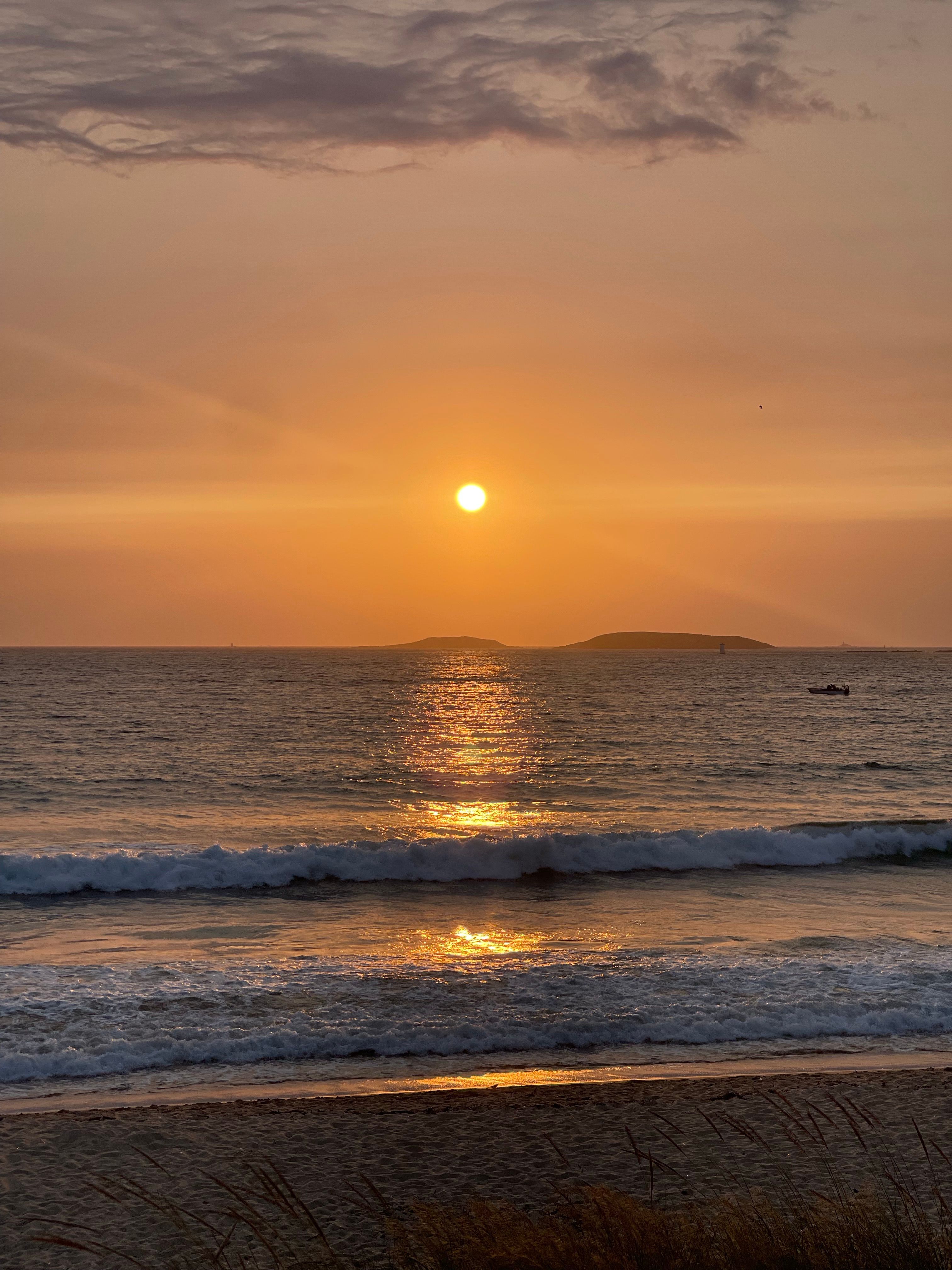 Stunning Beach Sunset Over Tranquil Ocean Waves · Free Stock Photo