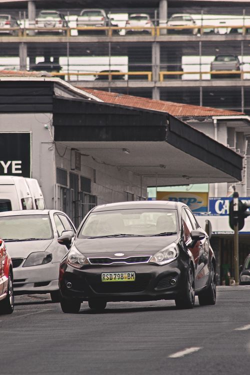 Free Dynamic street view capturing city life and traffic in Manzini, Eswatini. Stock Photo