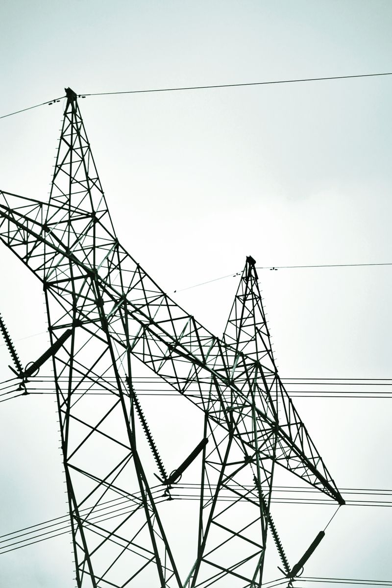 Silhouetted power lines and transmission towers