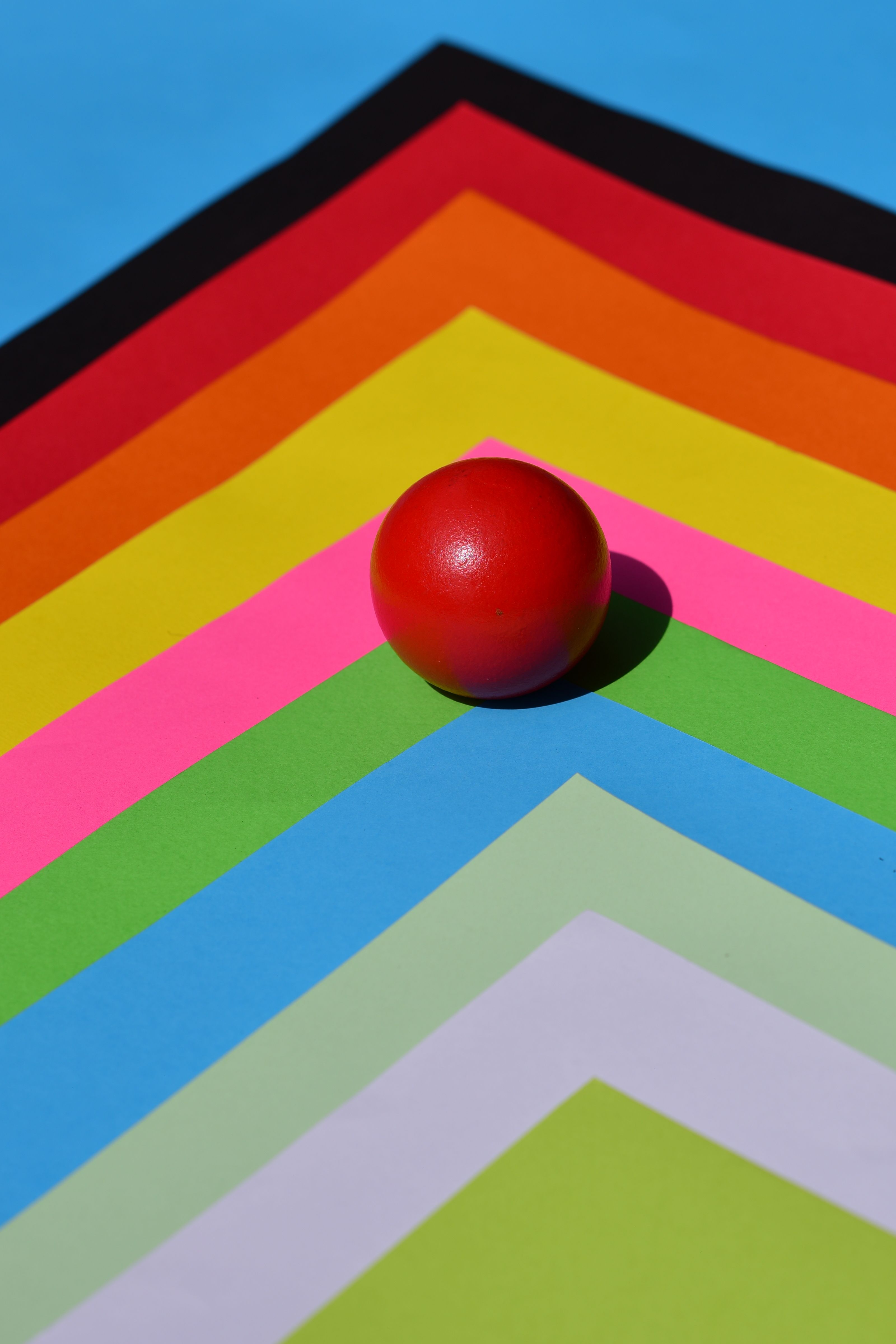 Vibrant Red Ball on Colorful Abstract Background · Free Stock Photo
