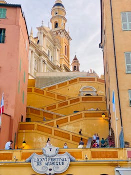 Colorful view of the ramped stairs leading to a basilica in Menton, showcasing architecture during the music festival.