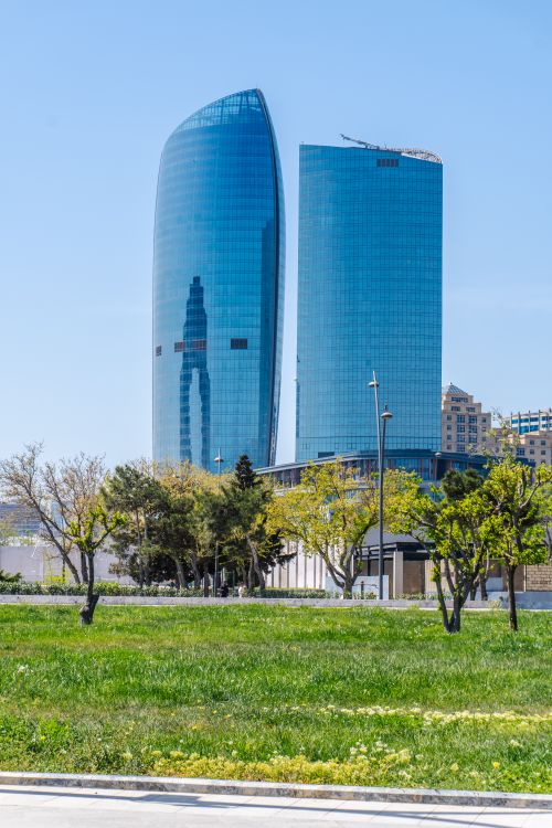 Free View of modern skyscrapers with vibrant green foreground in Baku, Azerbaijan. Stock Photo