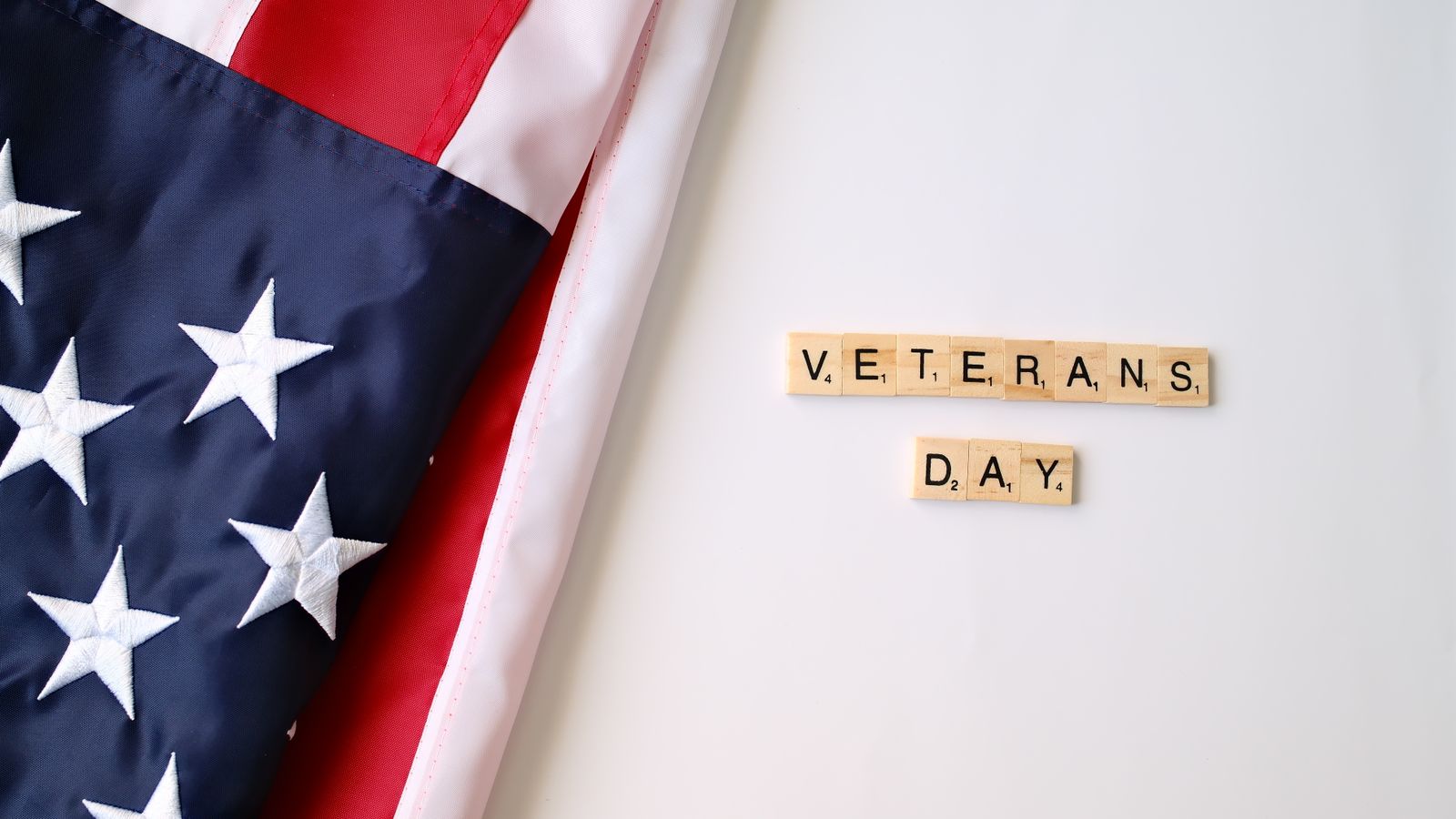 American flag and Veterans Day text on tiles symbolizing honor and patriotism.