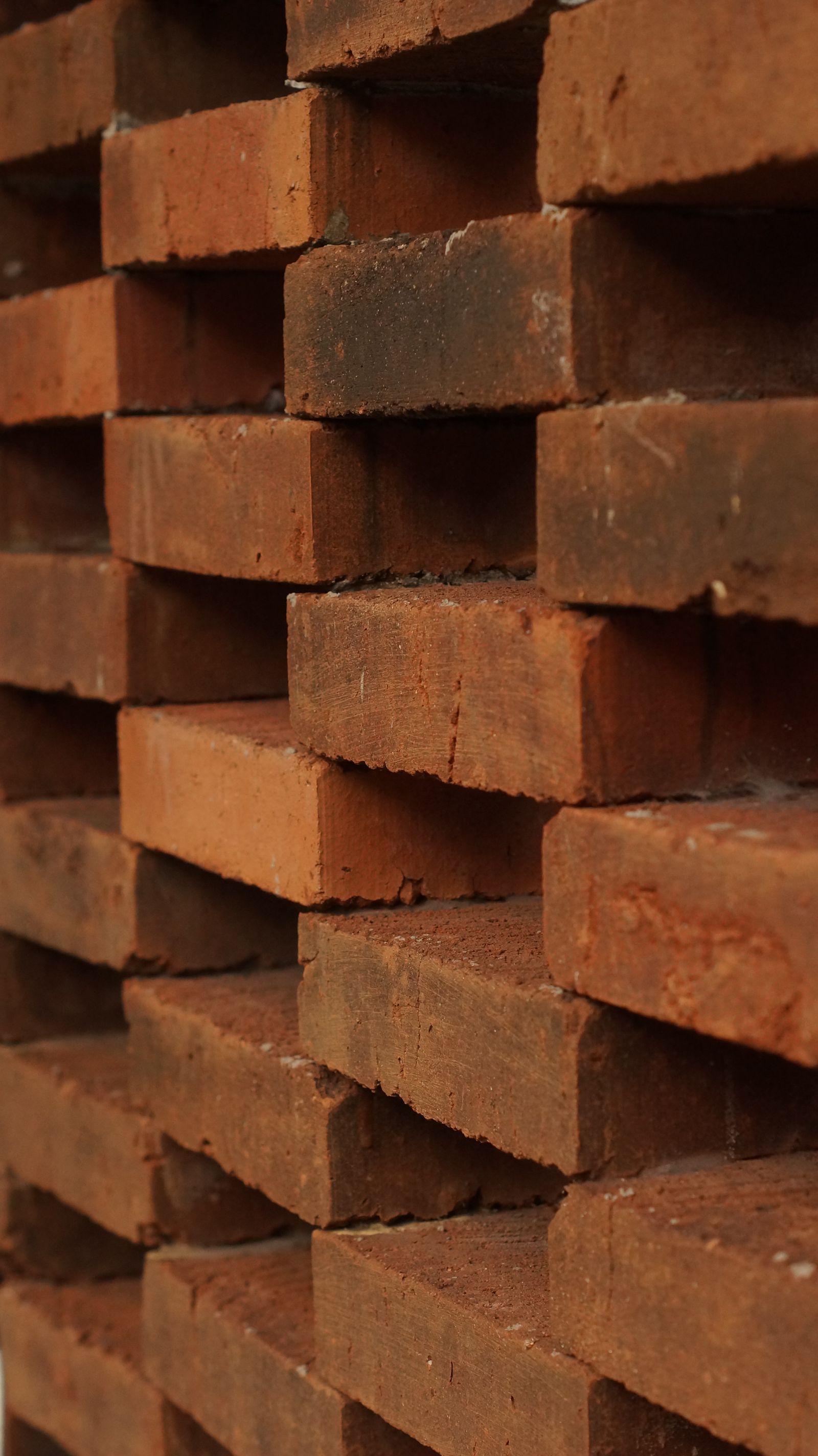Stacks of red bricks at a construction site