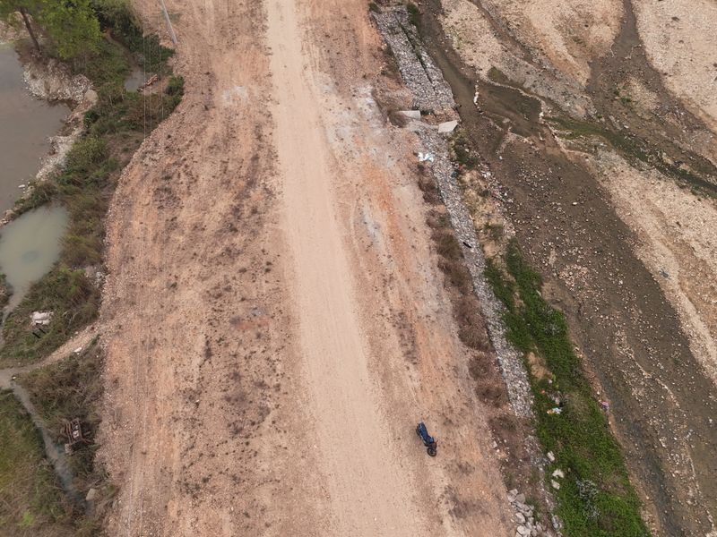 A dirt road running through dry rural country, seen from the air — photo by BD Shrestha on Pexels