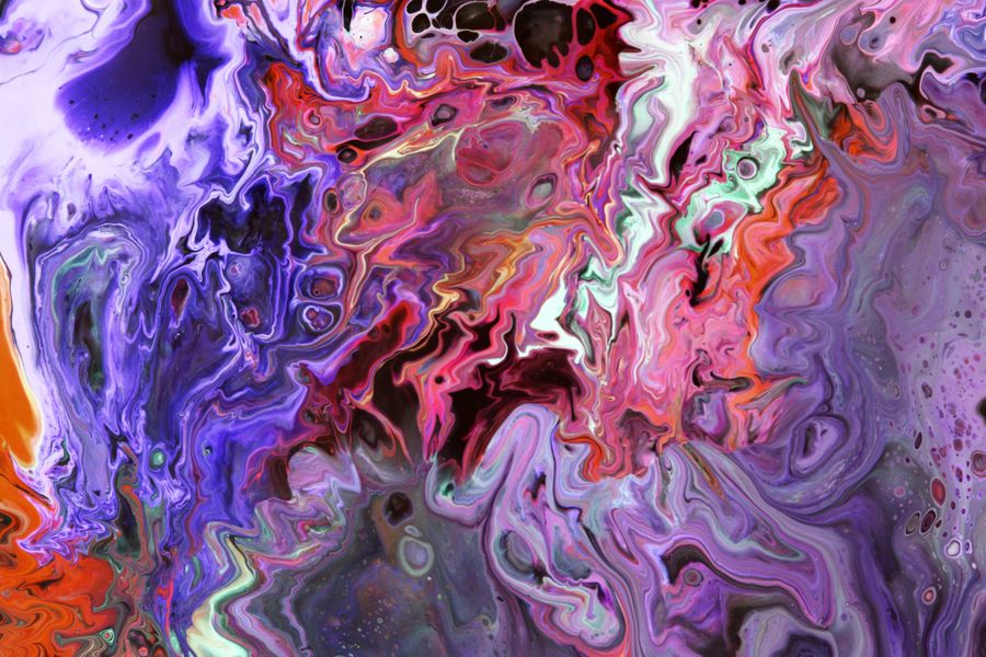 Vibrant abstract fluid art with swirling colors of purple, red, and orange.