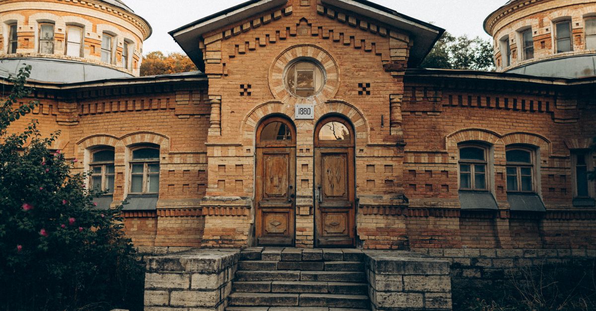 A historic symmetrical building featuring vintage architecture and unique brickwork.