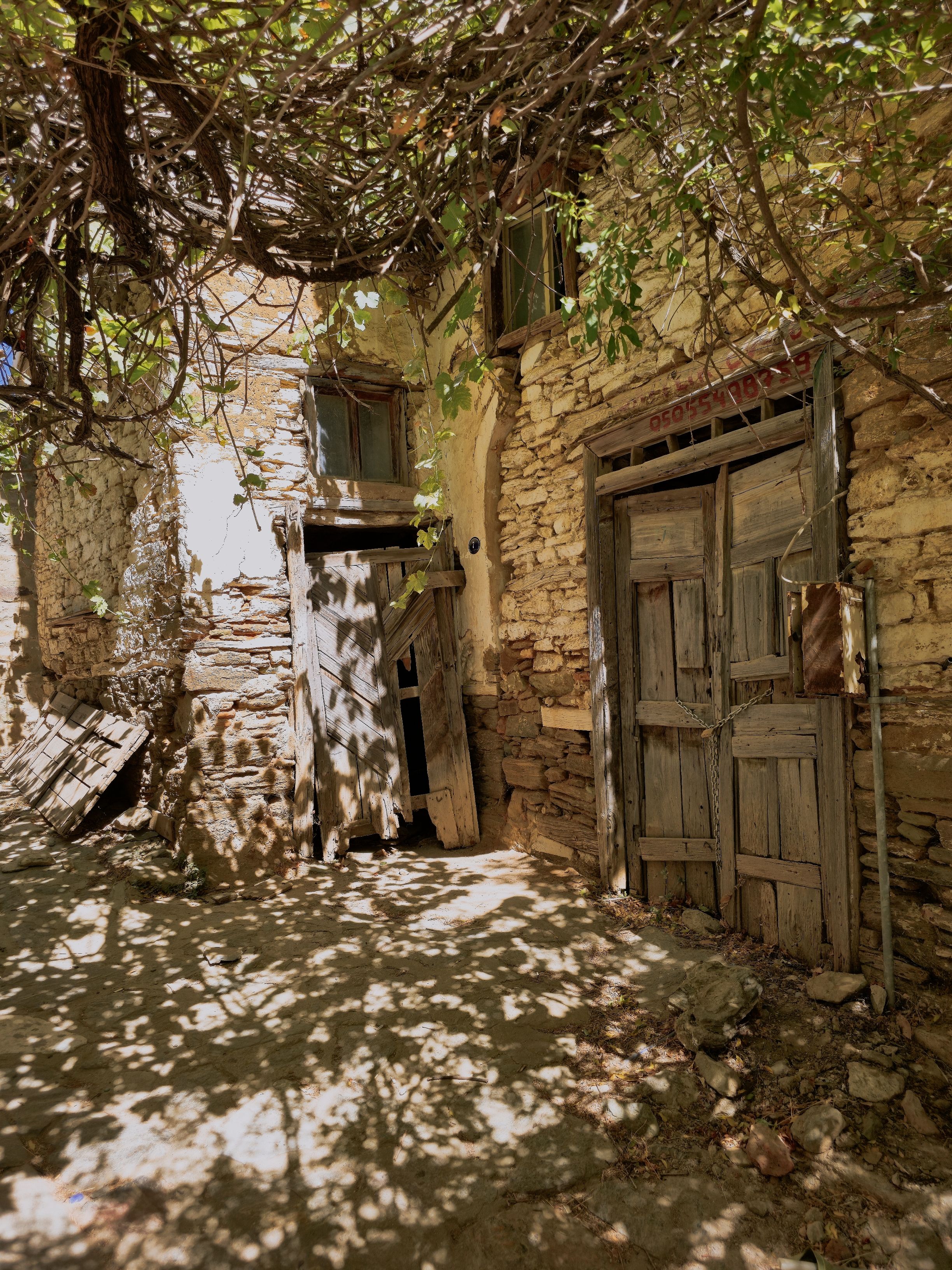 Rustic Abandoned Stone House with Wooden Doors · Free Stock Photo
