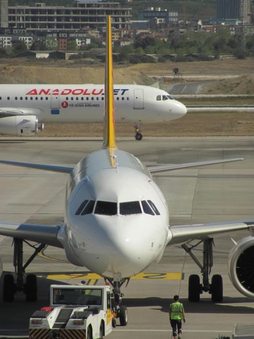 Free Front view of aircraft on runway with another plane in background at a busy airport. Stock Photo