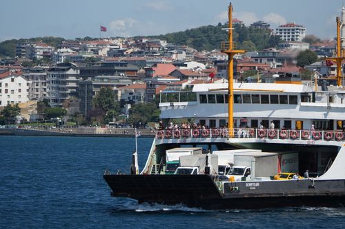 Free A ferry filled with passengers crossing the Bosporus with Istanbul's skyline in the background. Stock Photo