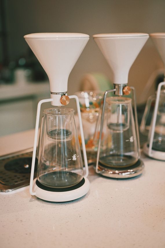 Modern coffee makers arranged on a clean kitchen counter