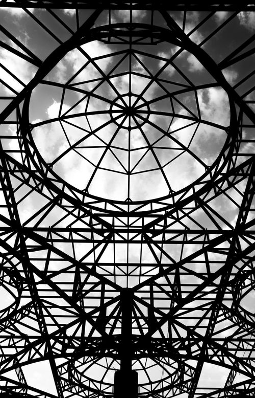 Free Black and white abstract view of a steel structure canopy with cloudy sky. Stock Photo
