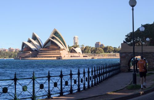 Free A picturesque view of the Sydney Opera House from a nearby walkway, capturing the iconic architecture. Stock Photo
