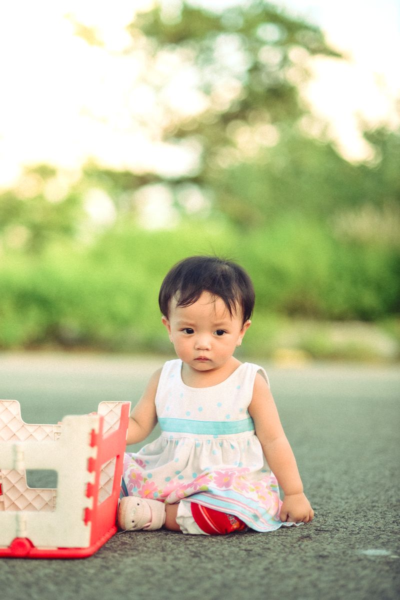 Adorable Asian baby sitting outdoors
