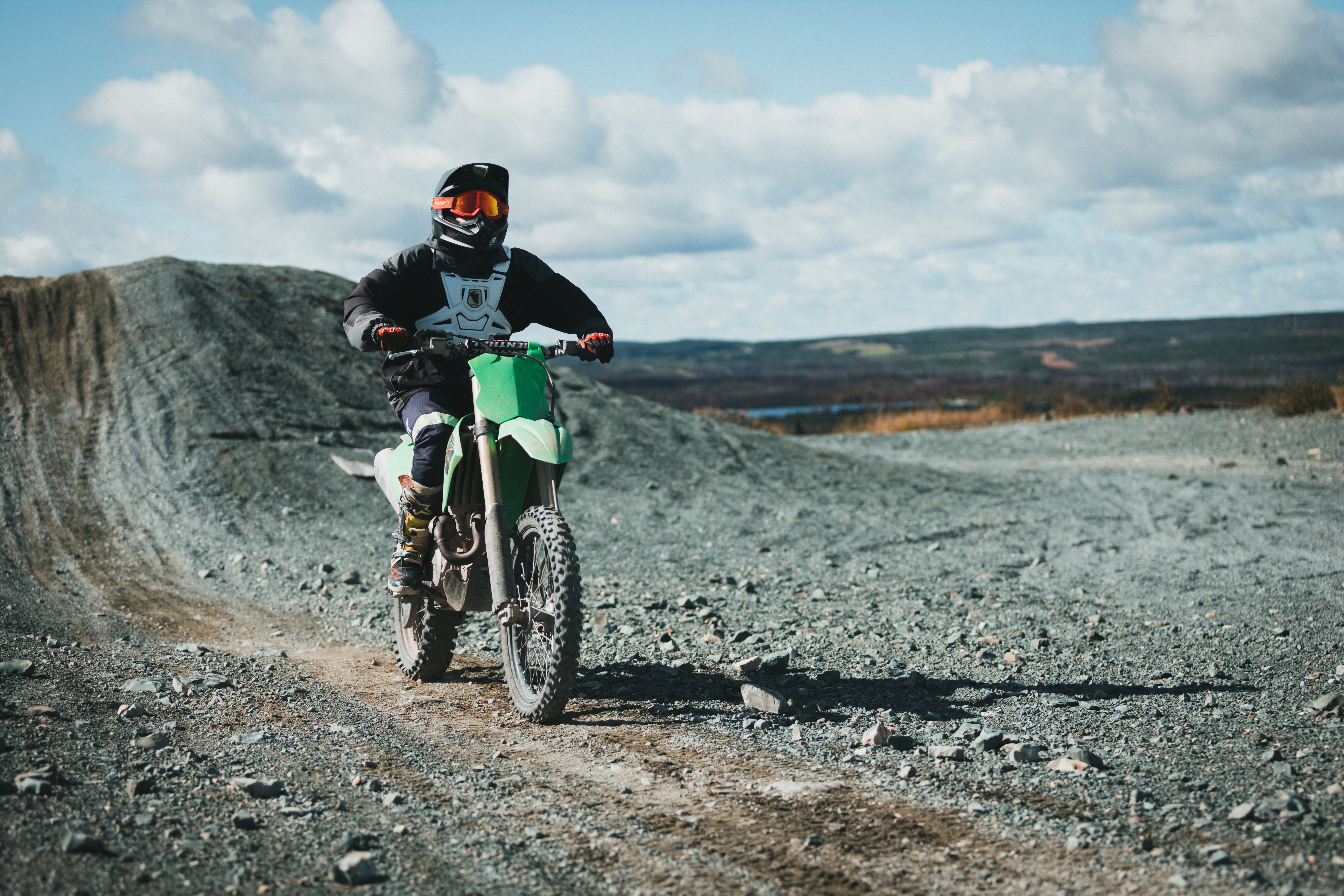 Dirt Bike Rider on Rocky Terrain During Daytime · Free Stock Photo