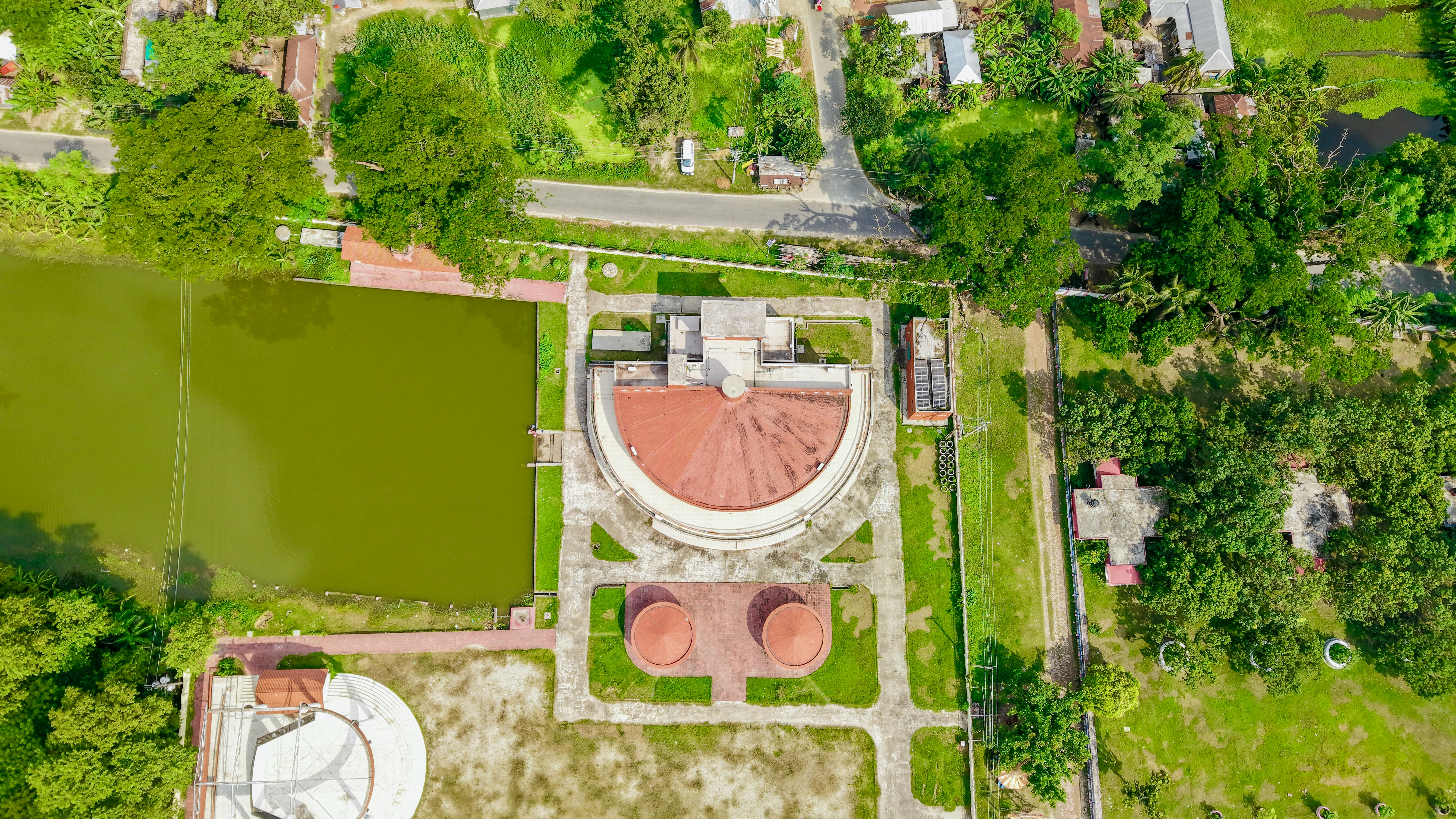 Drone capture of village landscape showcasing architecture and greenery.