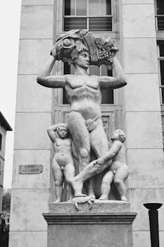 Intricate marble statue in Milan showcasing artistic craftsmanship in grayscale.