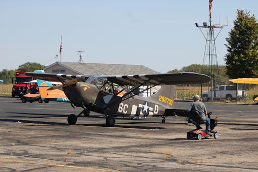 A vintage military airplane parked outdoors at Circleville Airport, Ohio, during a sunny day event.