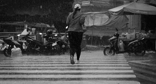 A woman crosses the street in rain-soaked Baguio, Philippines.
