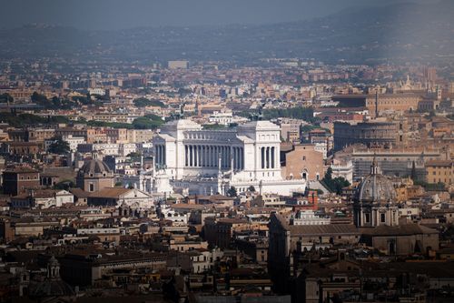 Free Breathtaking aerial view of Rome highlighting the iconic Vittoriano Monument amidst historic architecture. Stock Photo