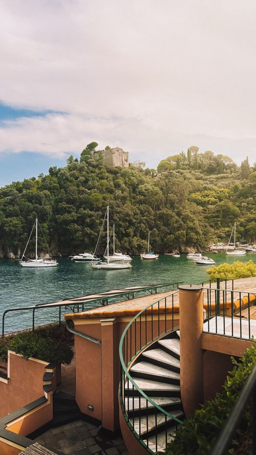 Free Beautiful view of Portofino bay with yachts and lush greenery under a bright sky. Stock Photo