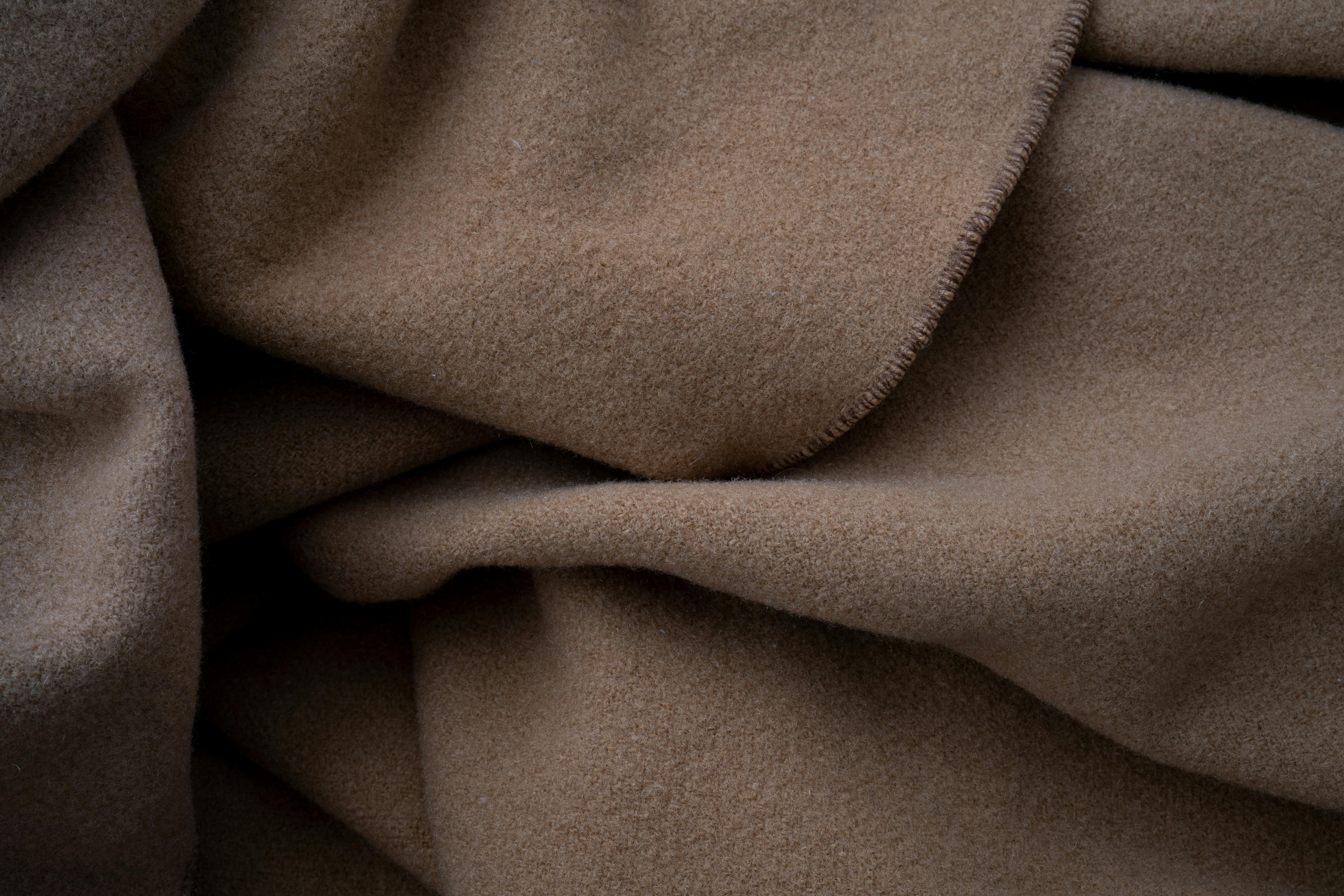 Close-up of a soft brown fabric, ideal for cozy and warm-themed projects.
