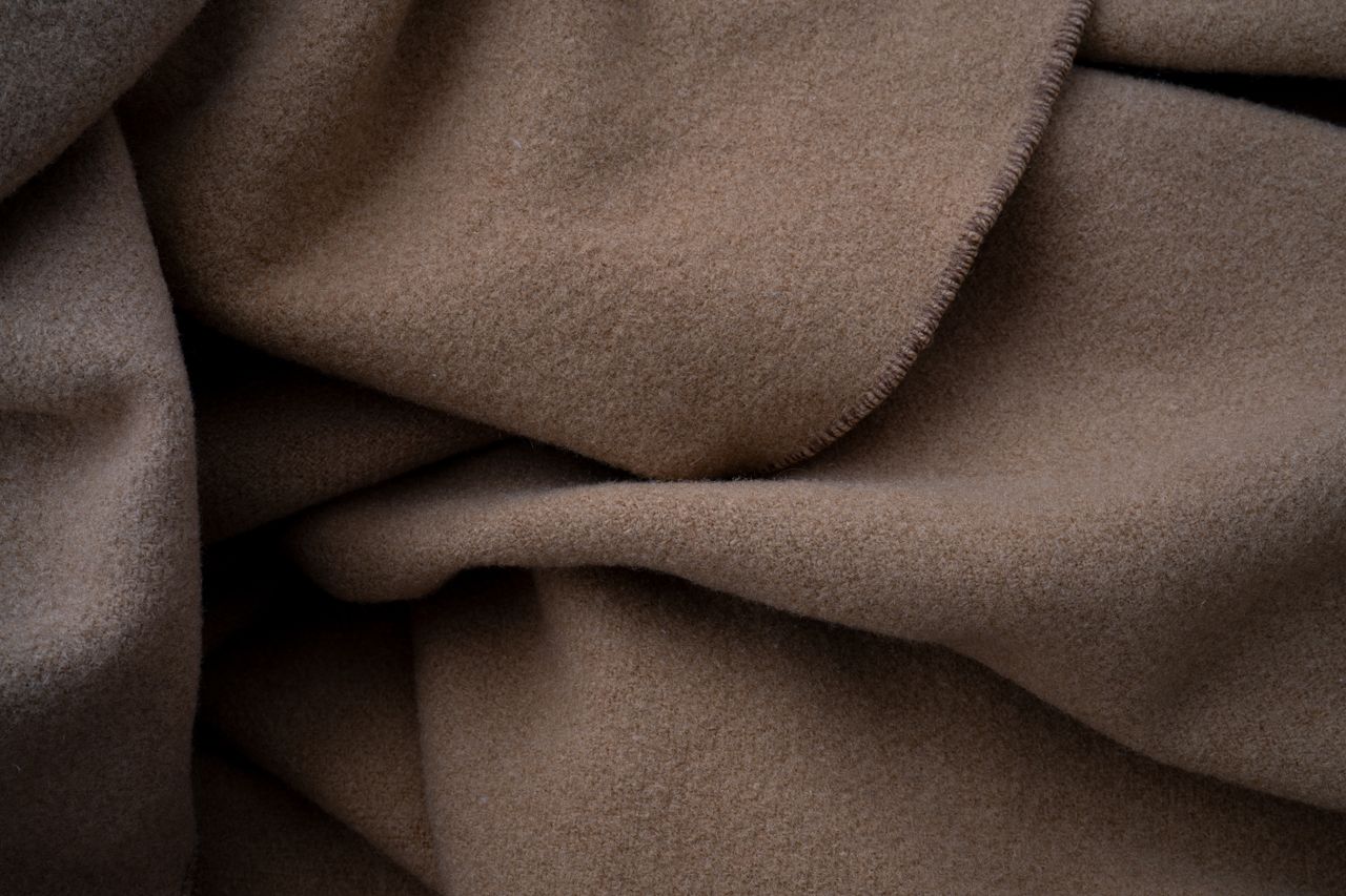 Close-up of soft brown wool fabric with visible fibres