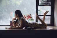 Young Woman Relaxing by the Window in Vintage Room